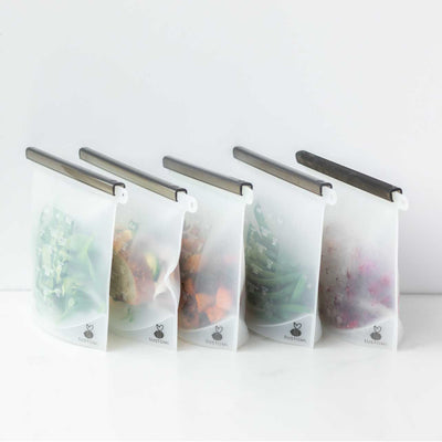 5 stylish silicone food pouches displayed storing food on a bench | SUSTOMi